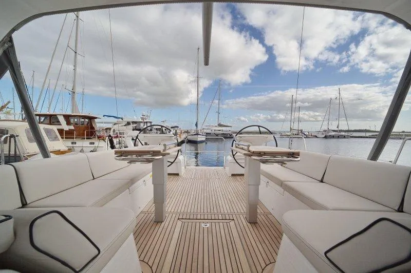  Yacht Photos Pics 2022 Beneteau Oceanis Yacht 54, spacious deck, marina view, luxury sailing experience.