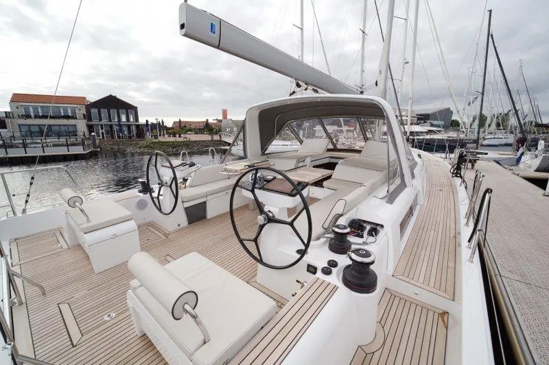  Yacht Photos Pics 2022 Beneteau Oceanis Yacht 54, elegant deck view, marina background, modern sailing design.