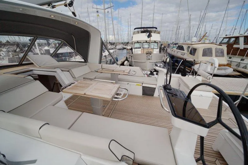  Yacht Photos Pics Luxurious 2022 Beneteau Oceanis Yacht 54 interior with elegant seating and steering wheel.