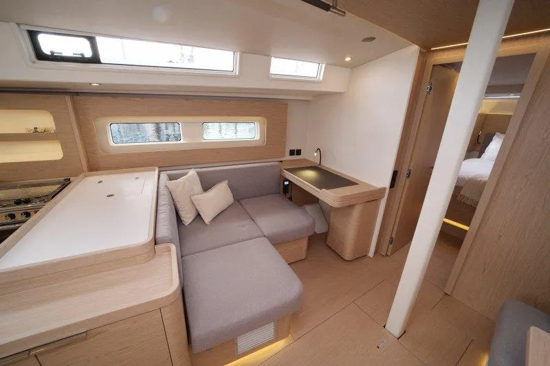  Yacht Photos Pics Interior of 2022 Beneteau Oceanis Yacht 54, featuring modern seating and elegant wood finishes.