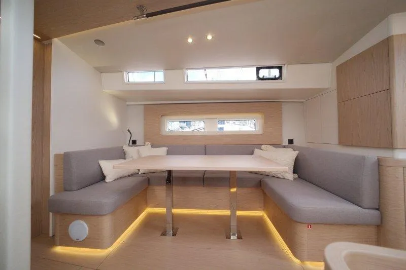  Yacht Photos Pics Modern interior of 2022 Beneteau Oceanis Yacht 54 with sleek seating and ambient lighting.