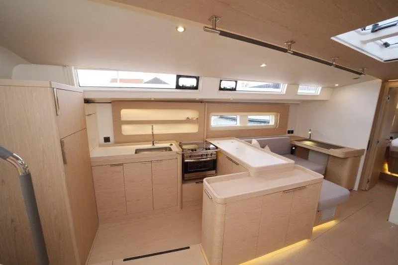  Yacht Photos Pics Luxurious interior of 2022 Beneteau Oceanis Yacht 54 with modern kitchen and seating area.
