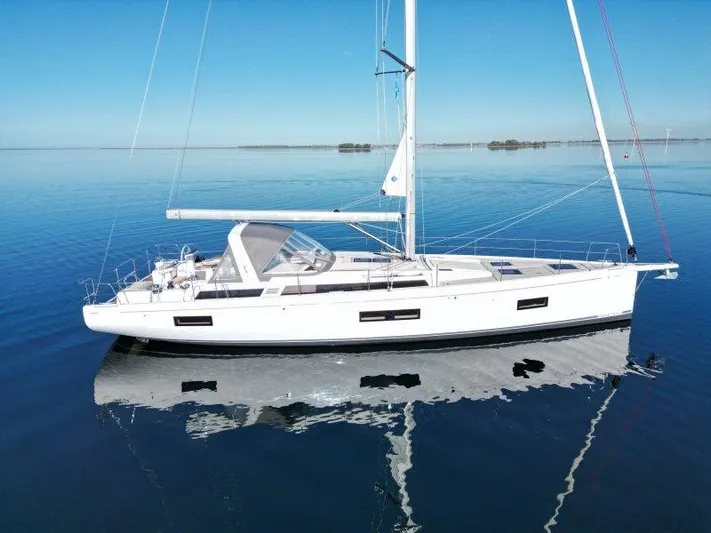 Yacht Photos Pics 2022 Beneteau Oceanis Yacht 54 sailing on calm blue waters.