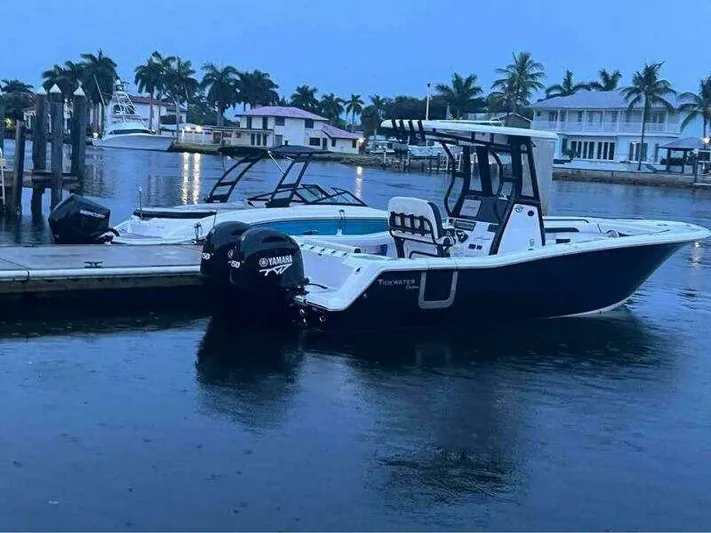  Yacht Photos Pics 2023 Tidewater 256 CC Adventure boat docked in a serene marina setting.