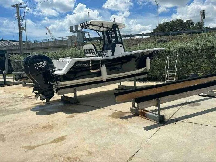  Yacht Photos Pics 2023 Tidewater 256 CC Adventure boat on trailer, Yamaha engine, outdoor setting.