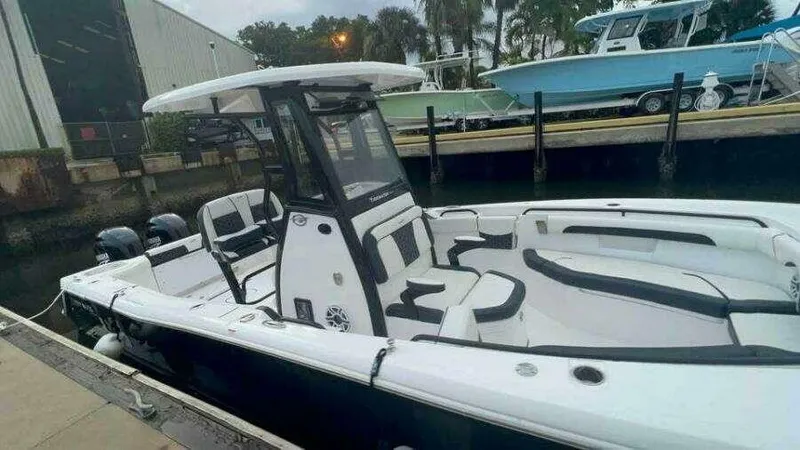  Yacht Photos Pics 2023 Tidewater 256 CC Adventure boat docked, featuring sleek design and spacious seating.