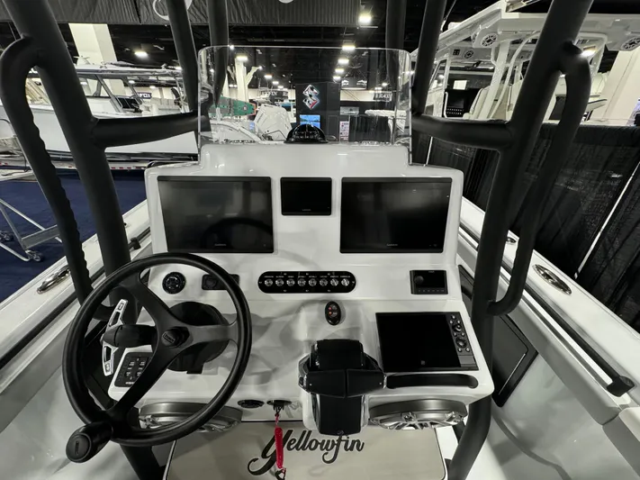  Yacht Photos Pics 2025 Yellowfin 26 Hybrid boat dashboard with dual screens and steering wheel.