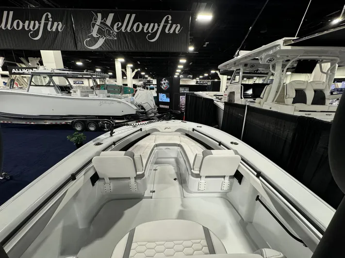  Yacht Photos Pics 2025 Yellowfin 26 Hybrid boat displayed at an indoor boat show.