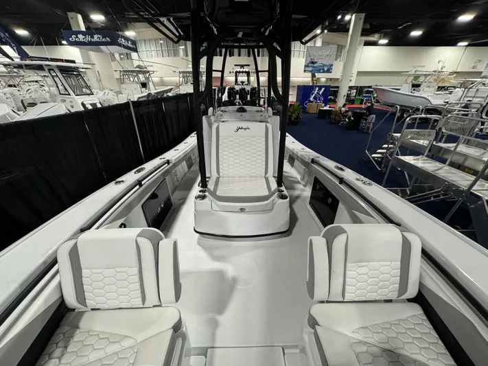  Yacht Photos Pics 2025 Yellowfin 26 Hybrid boat interior with white seating at a boat show.