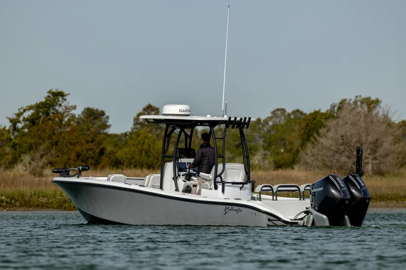  Yacht Photos Pics 2025 Yellowfin 26 Hybrid boat on water, featuring dual outboard motors and sleek design.