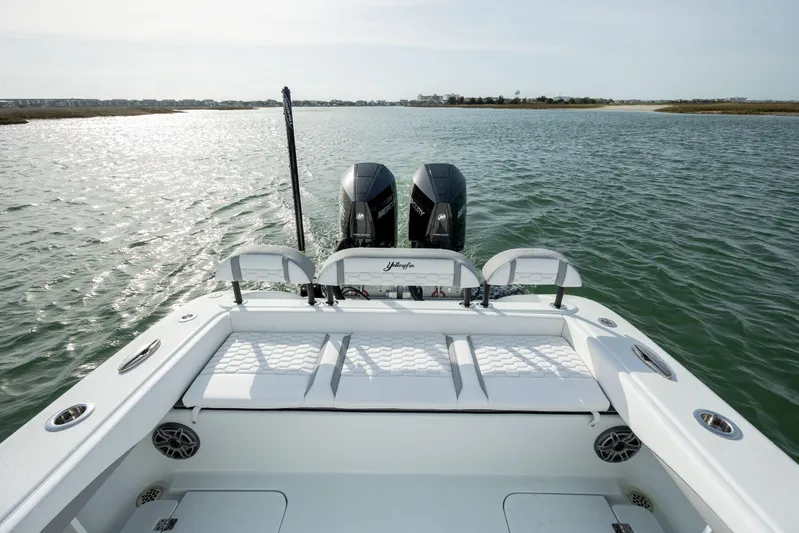  Yacht Photos Pics 2025 Yellowfin 26 Hybrid boat with dual engines on a serene waterway.