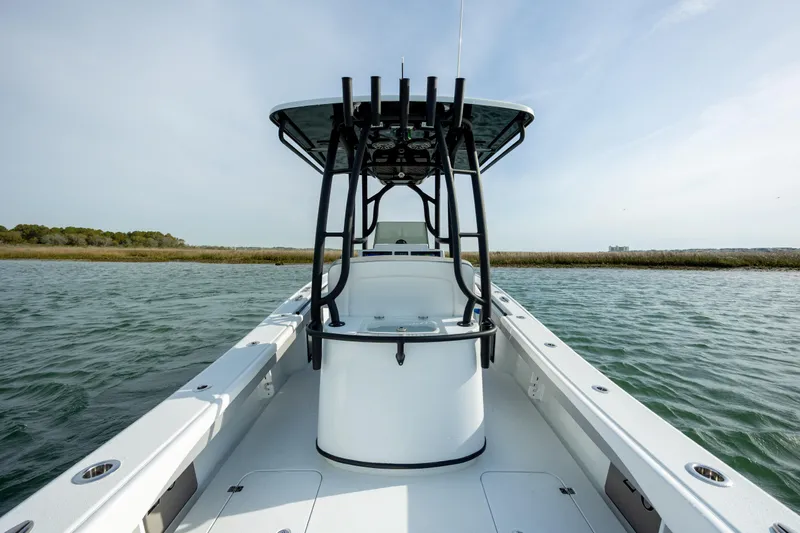  Yacht Photos Pics 2025 Yellowfin 26 Hybrid boat on water, showcasing sleek design and spacious deck.