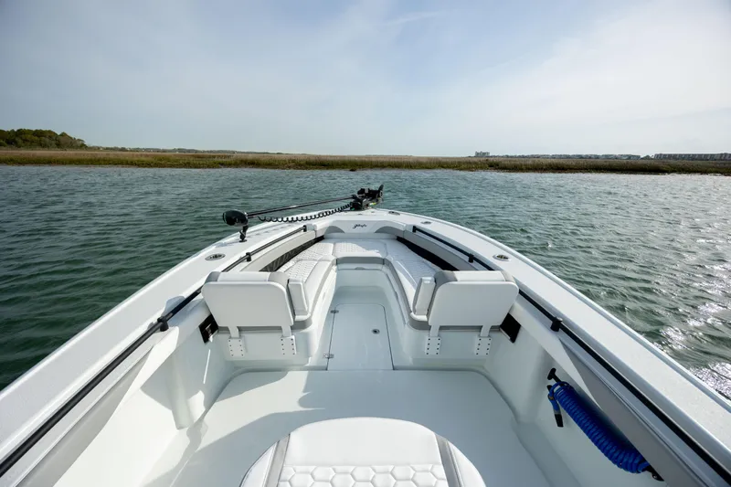  Yacht Photos Pics 2025 Yellowfin 26 Hybrid boat on water, featuring sleek design and comfortable seating.