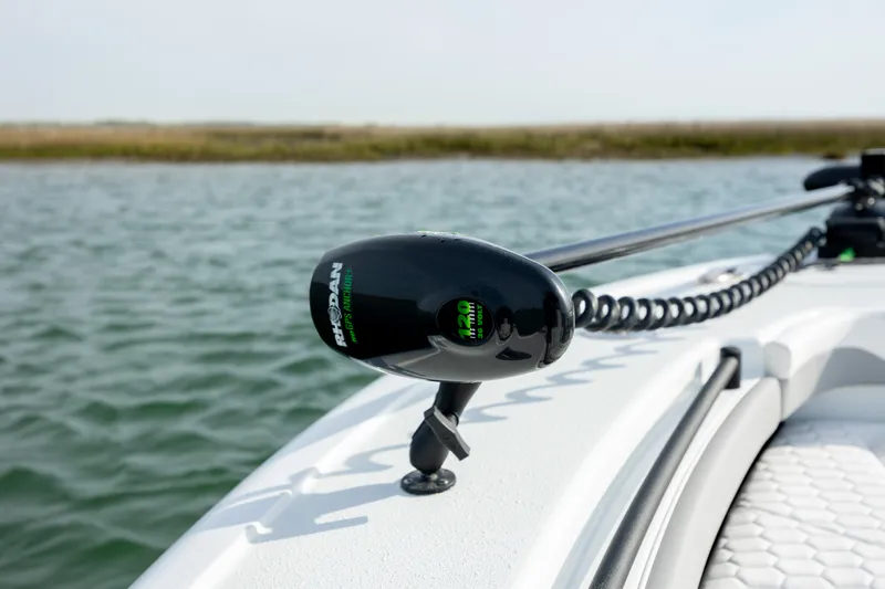  Yacht Photos Pics 2025 Yellowfin 26 Hybrid boat with trolling motor on calm water.