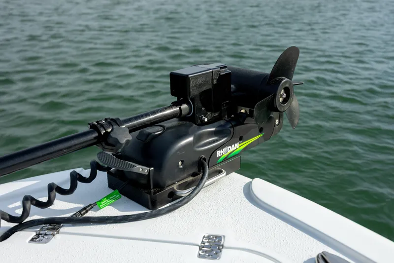  Yacht Photos Pics Trolling motor on 2025 Yellowfin 26 Hybrid boat, positioned on calm water.