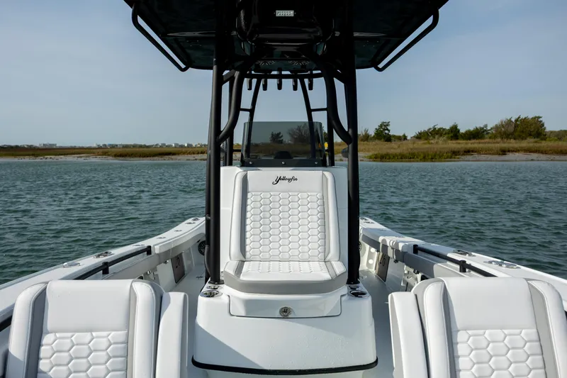  Yacht Photos Pics 2025 Yellowfin 26 Hybrid boat with sleek white seating on calm water.