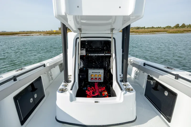  Yacht Photos Pics 2025 Yellowfin 26 Hybrid boat interior with open console, showcasing wiring and storage compartments.