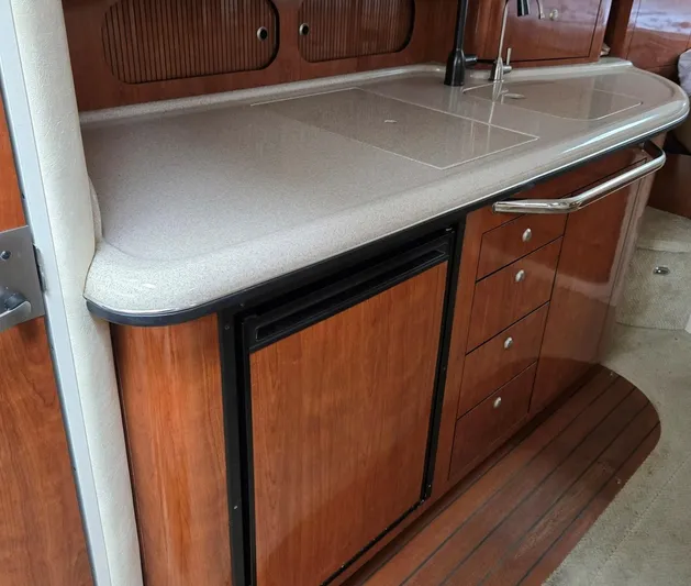 O Sea D Yacht Photos Pics 2007 Sea Ray 340 Sundancer interior kitchen with wood cabinetry and countertop.