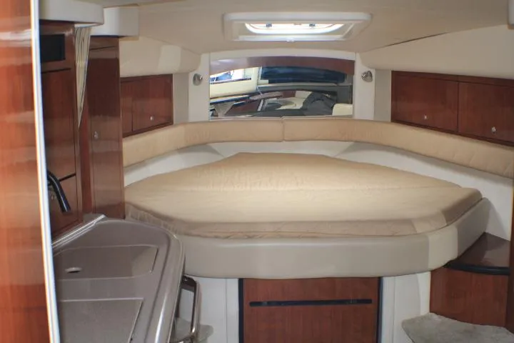 O Sea D Yacht Photos Pics Interior cabin of 2007 Sea Ray 340 Sundancer with cozy bed and wooden cabinetry.