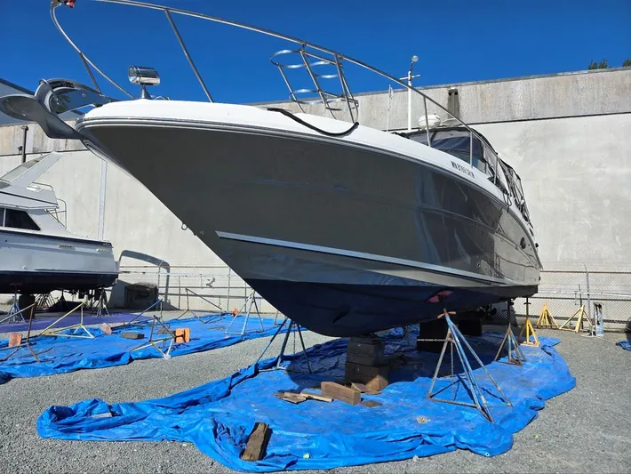 O Sea D Yacht Photos Pics 2007 Sea Ray 340 Sundancer yacht on stands, covered with blue tarps, in a boatyard.