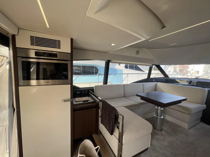 Yacht Photos Pics Luxurious interior of 2018 Prestige 460 Fly yacht with modern seating and dining area.