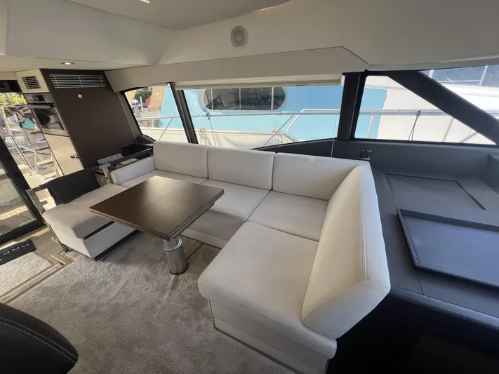  Yacht Photos Pics Luxurious interior of 2018 Prestige 460 Fly yacht with elegant seating and table.