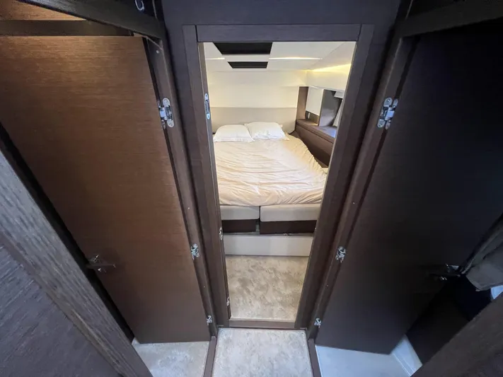  Yacht Photos Pics Luxurious bedroom interior of 2018 Prestige 460 Fly yacht, featuring a cozy bed and modern design.