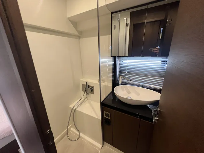  Yacht Photos Pics Modern bathroom interior on a 2018 Prestige 460 Fly yacht, featuring a sleek sink and shower.