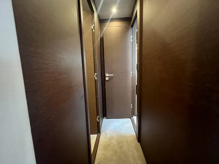  Yacht Photos Pics Hallway inside 2018 Prestige 460 Fly yacht with wooden doors and carpet flooring.