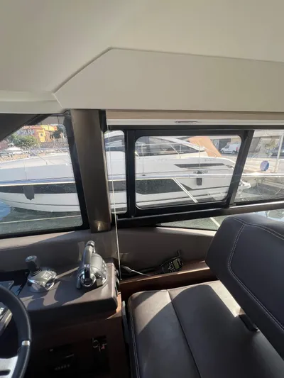  Yacht Photos Pics Interior view of a 2018 Prestige 460 Fly yacht cockpit with controls and seating.