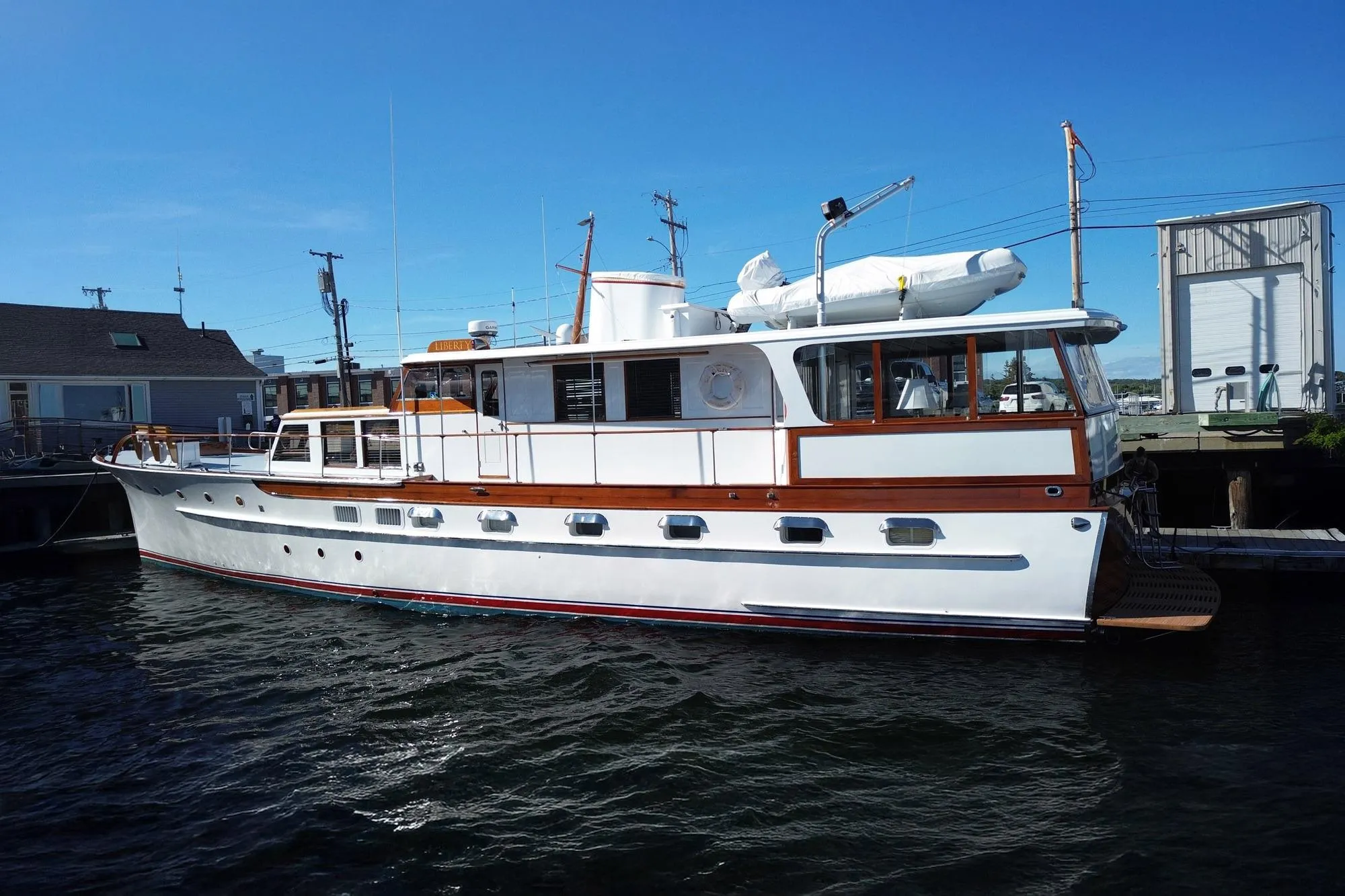 Classic 1954 Trumpy 68 Motor Yacht docked, showcasing elegant design and vintage charm.