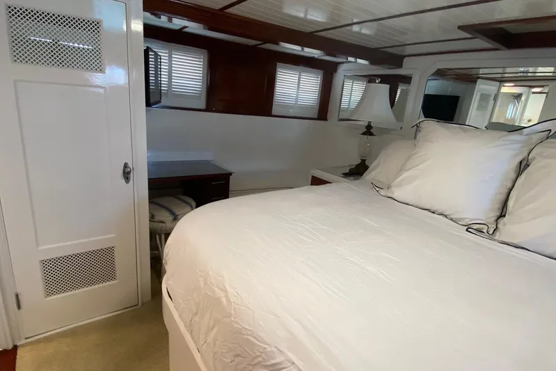 Liberty Love Yacht Photos Pics Luxurious bedroom interior of 1954 Trumpy 68 Motor Yacht with elegant white bedding.