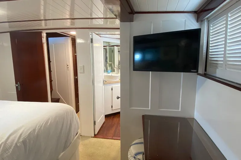 Liberty Love Yacht Photos Pics Interior of 1954 Trumpy 68 Motor Yacht with TV, bed, and bathroom view.