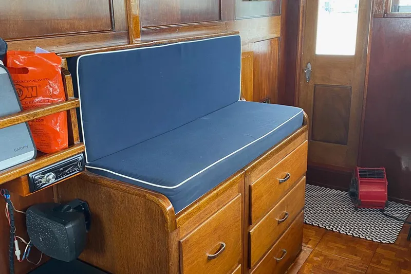 Liberty Love Yacht Photos Pics Interior of 1954 Trumpy 68 Motor Yacht with wooden cabinetry and blue cushioned seating.