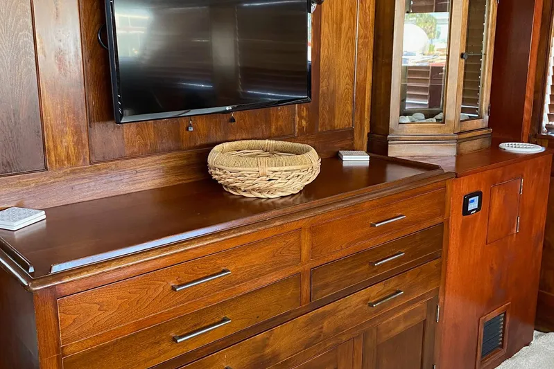 Liberty Love Yacht Photos Pics Interior of 1954 Trumpy 68 Motor Yacht with wooden cabinetry and mounted TV.