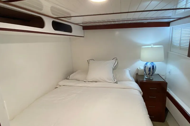 Liberty Love Yacht Photos Pics Cozy bedroom interior on a 1954 Trumpy 68 Motor Yacht with elegant bedding and lamp.