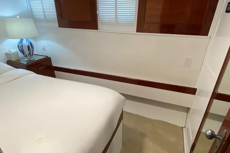 Liberty Love Yacht Photos Pics Cozy bedroom interior of 1954 Trumpy 68 Motor Yacht with elegant wood accents.