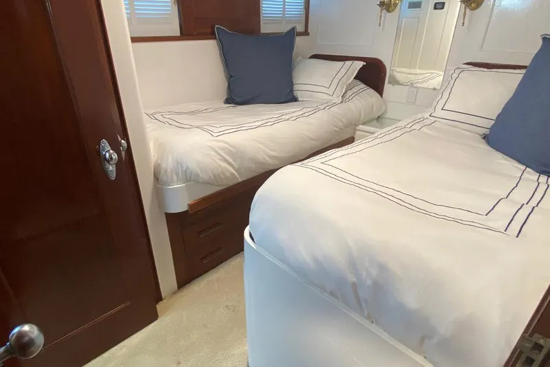 Liberty Love Yacht Photos Pics Cozy cabin interior of 1954 Trumpy 68 Motor Yacht with twin beds and elegant decor.