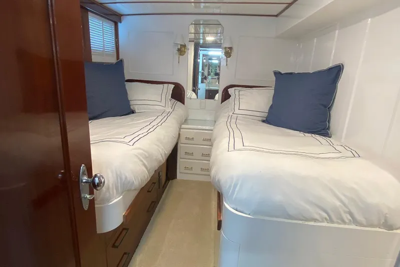 Liberty Love Yacht Photos Pics Cozy twin cabin in 1954 Trumpy 68 Motor Yacht with elegant bedding and wooden accents.