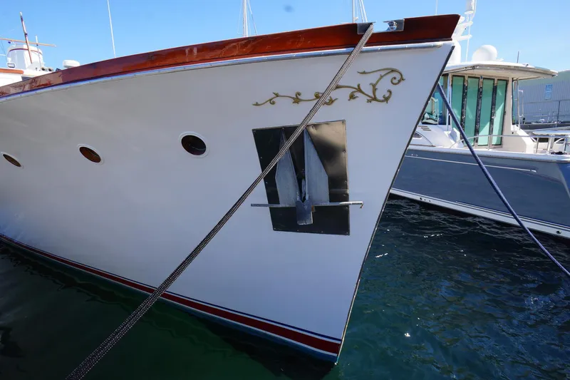 Liberty Love Yacht Photos Pics Classic 1954 Trumpy 68 Motor Yacht with elegant detailing, docked in clear waters.