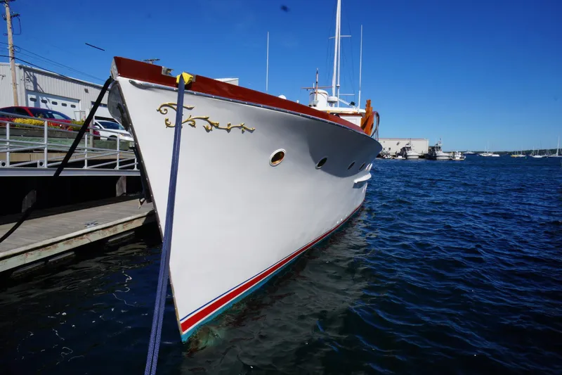 Liberty Love Yacht Photos Pics Classic 1954 Trumpy 68 Motor Yacht docked in a marina under clear blue skies.
