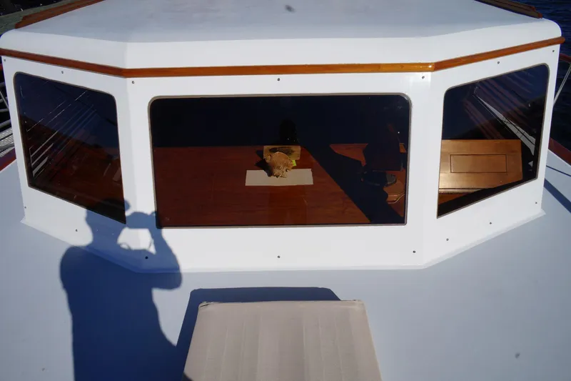 Liberty Love Yacht Photos Pics 1954 Trumpy 68 Motor Yacht cabin with reflective windows and wooden interior.