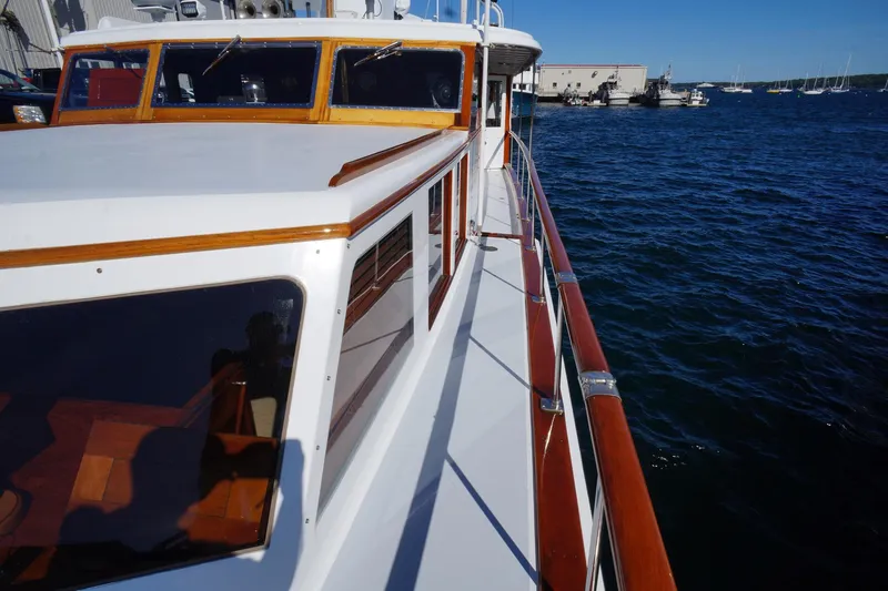 Liberty Love Yacht Photos Pics 1954 Trumpy 68 Motor Yacht on water, showcasing classic wooden details and sleek design.