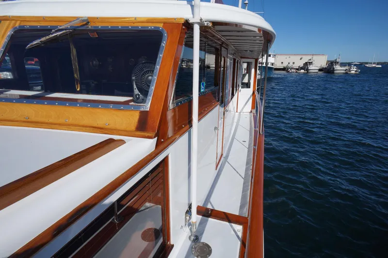 Liberty Love Yacht Photos Pics 1954 Trumpy 68 Motor Yacht with wooden details on a sunny day at the marina.