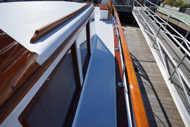 Liberty Love Yacht Photos Pics 1954 Trumpy 68 Motor Yacht deck with polished wood railings and dockside view.