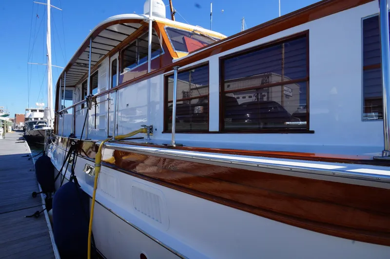 Liberty Love Yacht Photos Pics Classic 1954 Trumpy 68 Motor Yacht docked, showcasing elegant wooden design and craftsmanship.