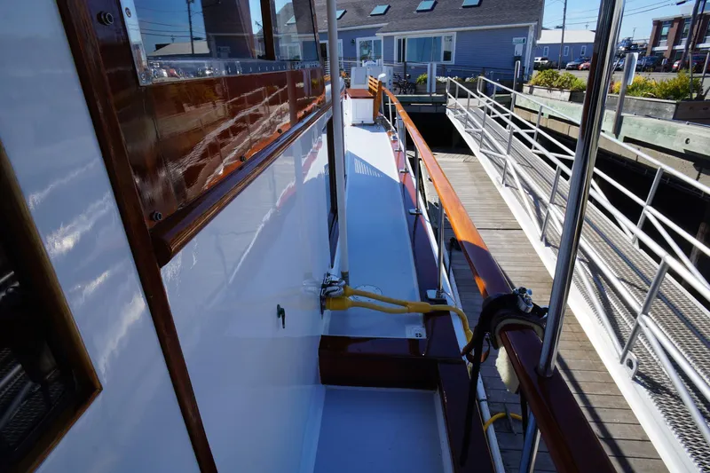 Liberty Love Yacht Photos Pics 1954 Trumpy 68 Motor Yacht docked, showcasing polished wood and sleek design.