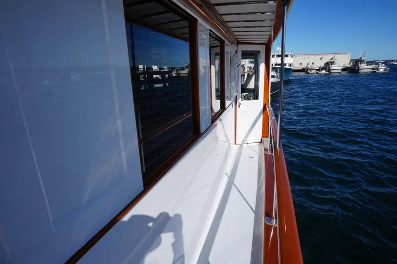 Liberty Love Yacht Photos Pics Side view of 1954 Trumpy 68 Motor Yacht on water, showcasing sleek design and craftsmanship.