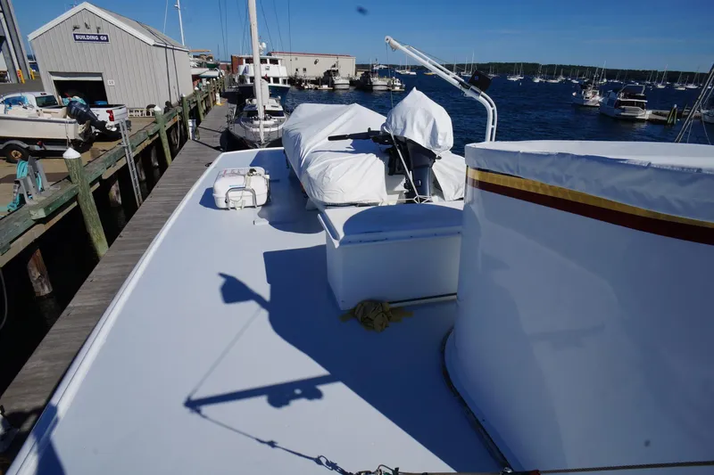 Liberty Love Yacht Photos Pics 1954 Trumpy 68 Motor Yacht docked at marina, covered deck, clear blue sky.