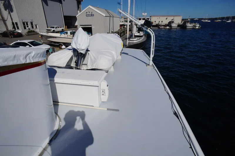 Liberty Love Yacht Photos Pics 1954 Trumpy 68 Motor Yacht docked at marina, showcasing deck and covered equipment.